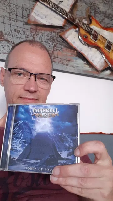 A fan holding the Songs of Power CD