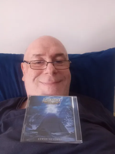 A fan holding the CD and the band card